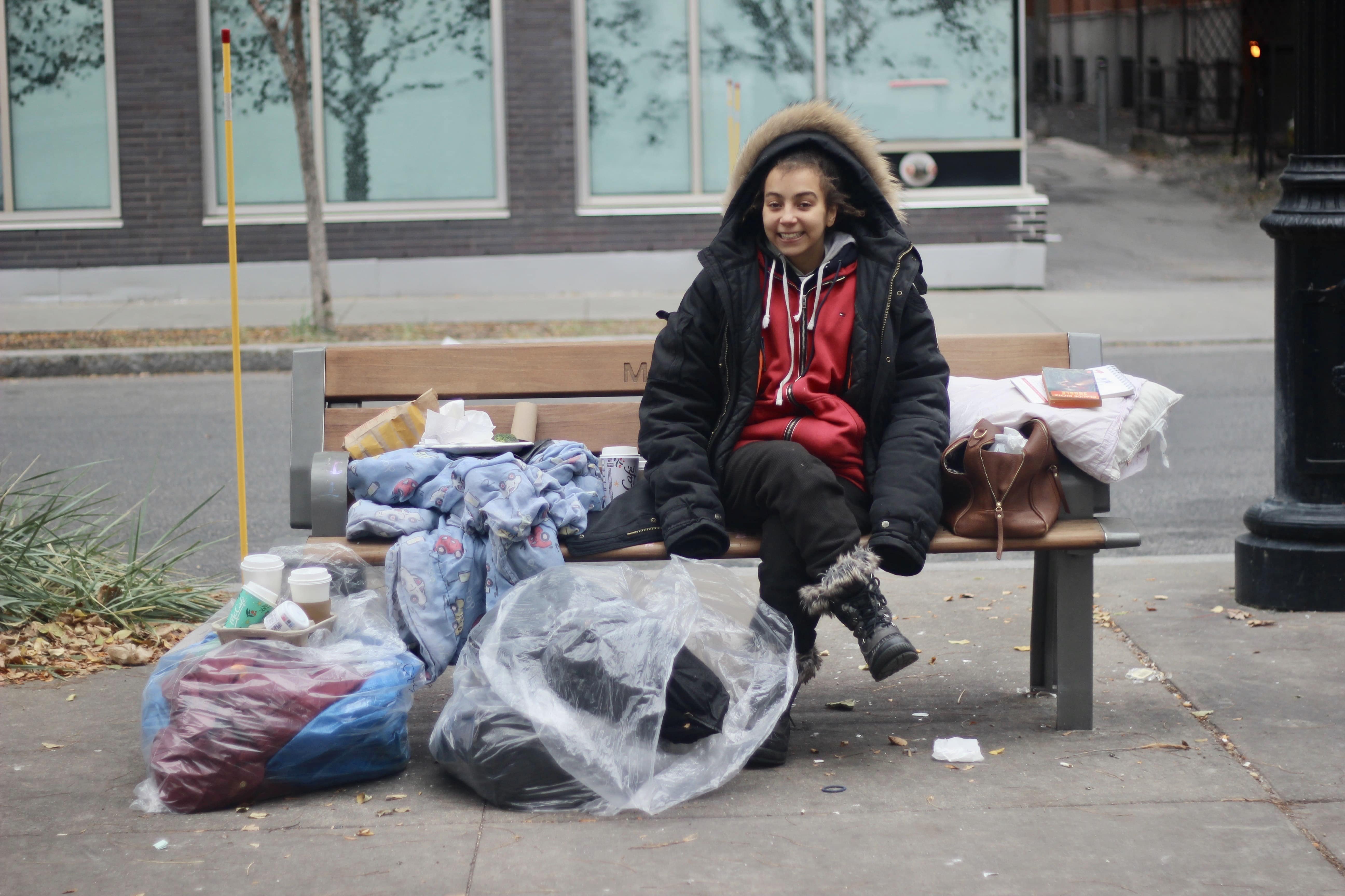 Homeless woman sitting on a bench